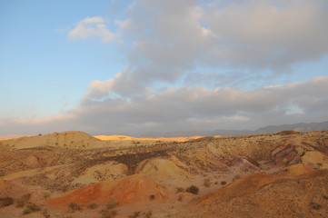 Fototapeta na wymiar Desert landscape at sunrise. Hiking desert part of Israel National Trail. Negev desert . Valley. Colorful sands 