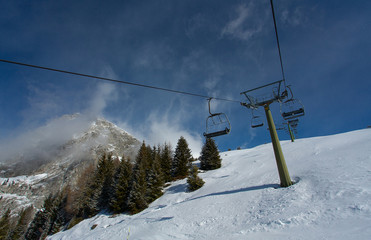 Fototapeta na wymiar riding on a ski lift over forest