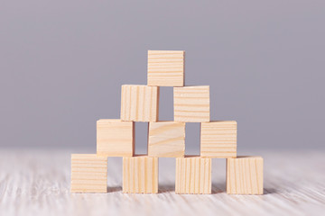 wood cube stacking as step stair. Business concept growth success process on blue background, copy space.