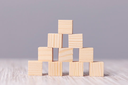 wood cube stacking as step stair. Business concept growth success process on blue background, copy space.