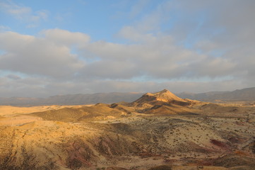 Fototapeta na wymiar Desert landscape at sunrise. Hiking desert part of Israel National Trail. Negev desert . Valley. Colorful sands 