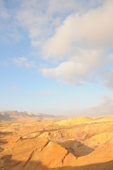 Naklejka premium Desert landscape at sunrise. Hiking desert part of Israel National Trail. Negev desert . Valley. Colorful sands 