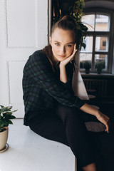 Close up portrait of young fashionable girl in stylish cafe. Youth, new generation, lifestyle concept