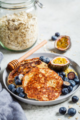 Oatmeal pancakes with honey, fruits and berries. Healthy vegan food concept.