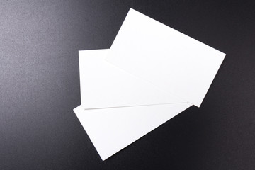 white blank business cards isolated  on black background. close-up