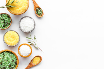 Spa cosmetics. Set of salt in bowls on white wooden background top-down frame copy space
