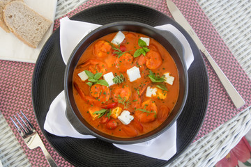 Shrimp with spicy tomato sauce, feta cheese and herbs	