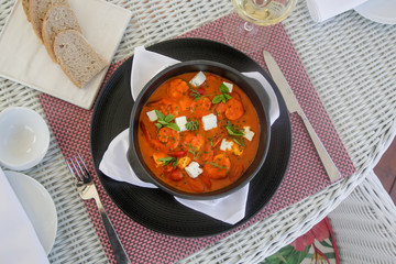 Shrimp with spicy tomato sauce, feta cheese and herbs	