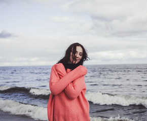 Trendy portrait woman on sea beach in stylish wear, brunette hipster enjoy the sea.