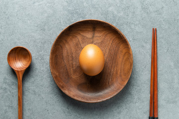 an egg on wooden plate
