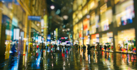 Obraz premium pedestrians walking on rainy night in the city vienna 