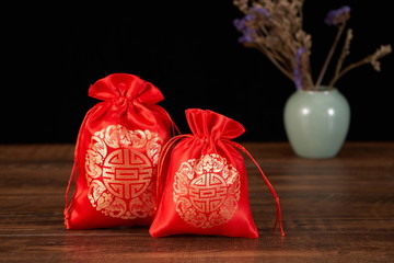 The traditional Chinese Red sachet is embroidered with a blessing pattern, indicating peace and...
