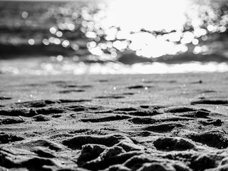 Footprints of feet on the beach at the sea
