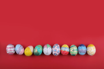 painted handmade easter eggs on a red background