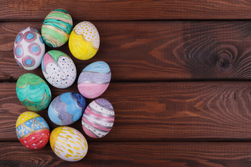 painted handmade easter eggs on a wooden table background