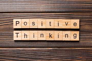 positive thinking word written on wood block. positive thinking text on table, concept