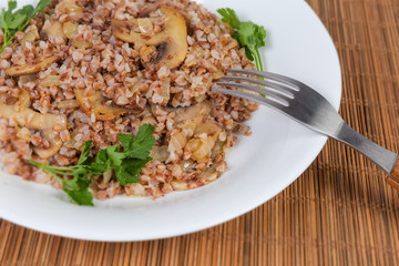 Buckwheat porridge with fried mushrooms and onions, fragment close-up