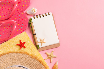 Flat lay, top view Travel concept. summer accessories with note paper and seashell on pink background