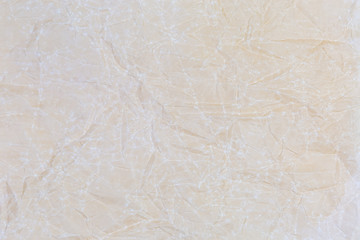 Background of crumpled parchment paper, fragment close-up, texture
