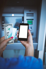 Fototapeta na wymiar Woman using modern ATM nashine - cash withdrawal.