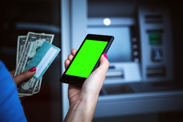 Woman using modern ATM nashine - cash withdrawal.
