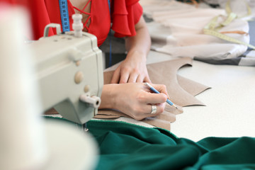 Obraz na płótnie Canvas Female tailor working in modern atelier