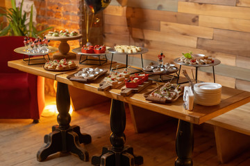 Fototapeta na wymiar Catering table, beautiful wooden table, warm light.