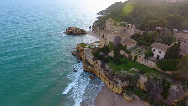 Aerial view of Marquises Castle in front of coastline. Sunset in Tamarit, Tarragona province, Spain