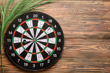 Dartboard hanging on wooden wall