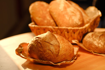 Assortment of baked bread on wooden table background. Bread background, top view of white, black and rye loaves. Healthy food. 