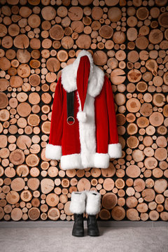 Santa Claus Costume Hanging On Wooden Wall