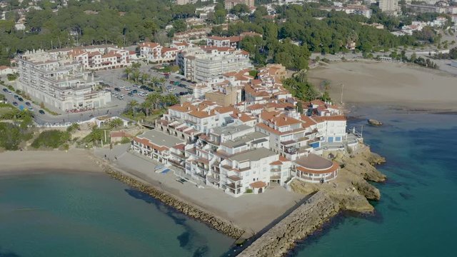 Aerial panoramic landscape over typical fishing village turned into a tourist center. Village name is Roc de Sant Gaieta, Tarragona province, Spain