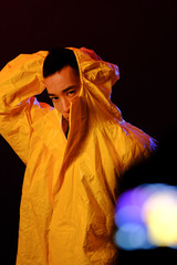 Asian man in a yellow suit of chemical protection on a colored trendy background. Conceptual fashion fashion shooting.