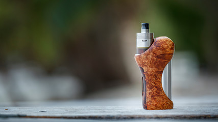 high end titanium genesis atomizer with ultem tank on stabilized natural black ash wood regulated...