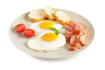 Plate with fried eggs, bacon and bread on white background