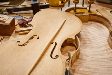 Luthier workshop with violin parts and tools. Traditional craftmanship. - Powered by Adobe