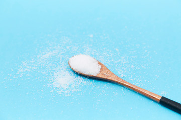 Salt in the wooden spoon on the table
