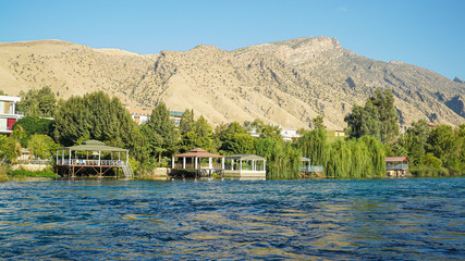 lake Dokan tourist area on the river and mountains in the background in Sulaymaniyah province in Kurdistan region of Iraq