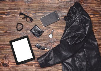 Stylish male clothes with accessories and tablet computer on wooden background