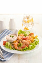 Grilled shrimp salad with fresh lettuce, cherry tomatoes and creamy sauce.