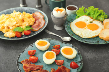 Different tasty dishes with eggs on table