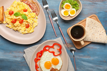 Different tasty dishes with eggs and coffee on table