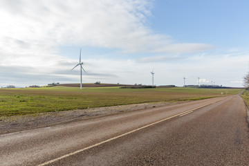 Fototapeta na wymiar Windmills on the rural grassland