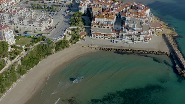 Aerial view of tourist landscape Coastal town with typical white fishermen's houses and orange tile roofs at Roc de Sant Gaieta, Tarragona province in Catalonia, Spain