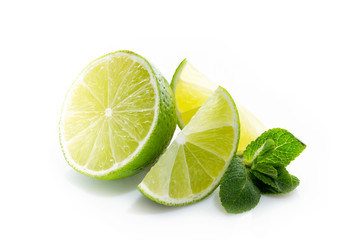 Fresh lime. Slices of ripe and juicy lime with green mint leaves close-up