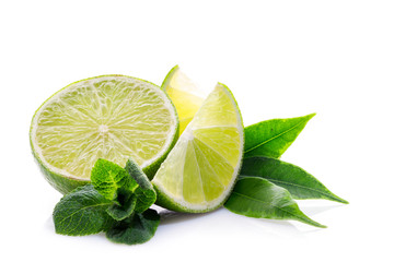 Slices of ripe and juicy lime with green mint leaves close-up