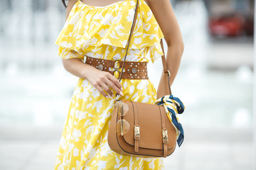 Women`s accessories. Female holding her purse close up.