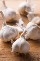 A lot of garlic on a wooden background. Close-up