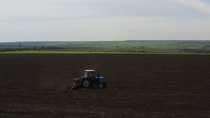 Aerial view of farm machine plowing the land