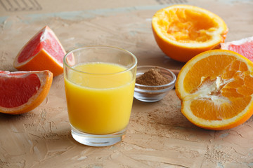 Organic foods orange, grapefruit, juice and aromatic cinnamon. Brown background.